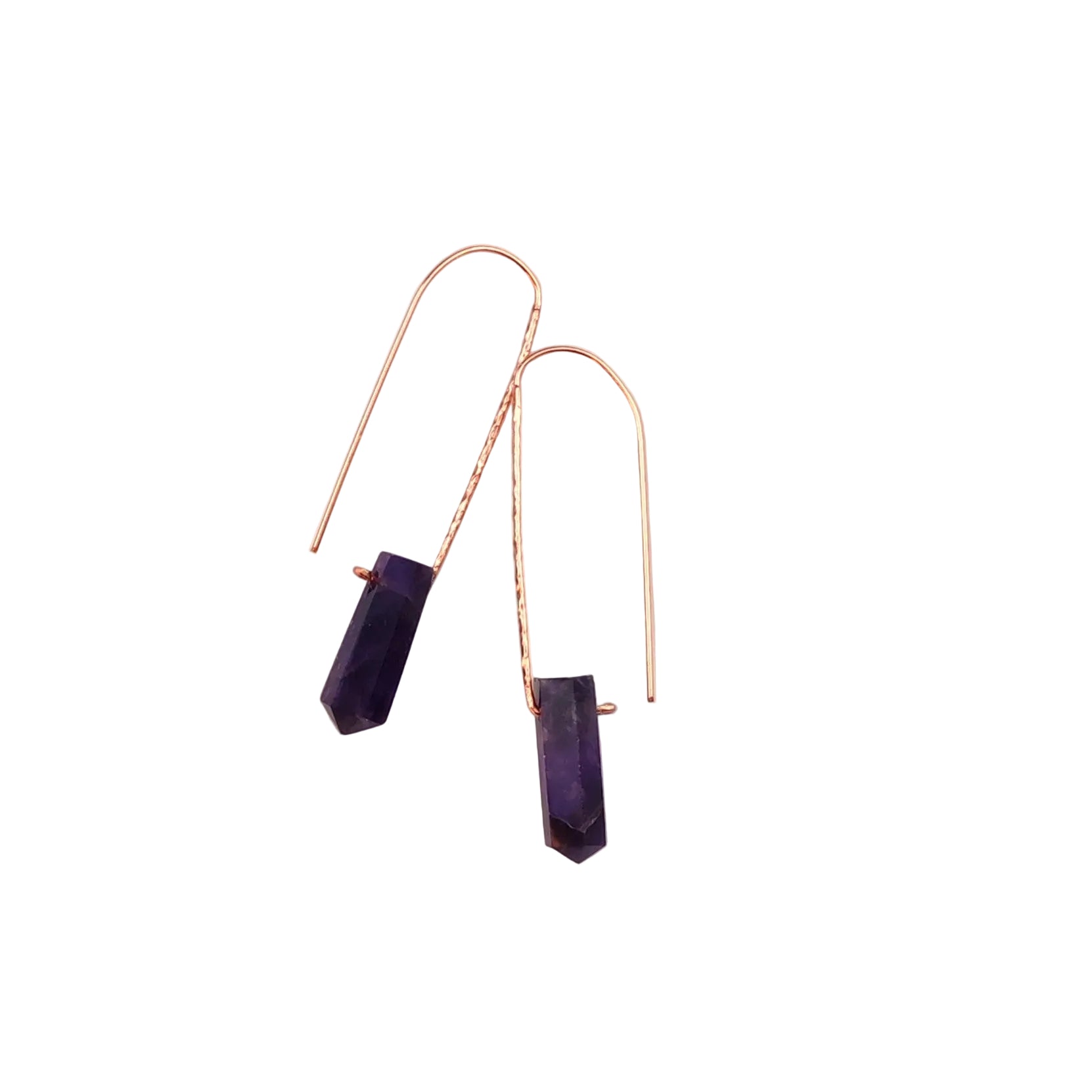 Pair of purple crystal earrings on a beige background